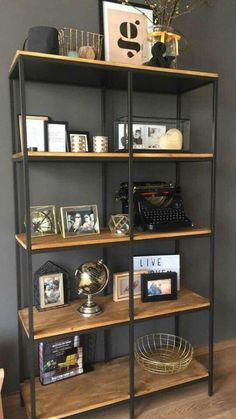 a book shelf with books and pictures on it