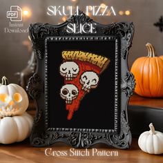 there is a cross stitch picture with skulls on it and pumpkins in the background