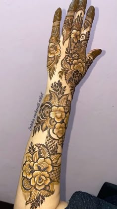 a woman's hand with henna tattoos on it