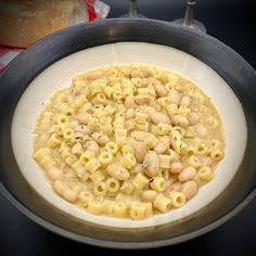 a bowl filled with macaroni and cheese on top of a table