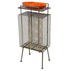 a metal stand with an orange bowl on top