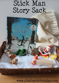 a basket filled with toys sitting on top of a wooden table next to a book