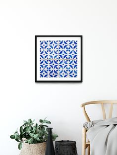 a white wall with a blue and white tile pattern hanging on it's side