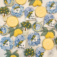 decorated cookies with lemons and leaves are arranged on a table