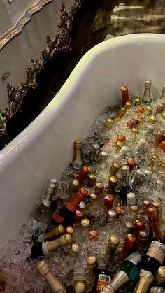 a bath tub filled with lots of bottles and ice