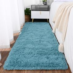 a bedroom with a blue rug on the floor