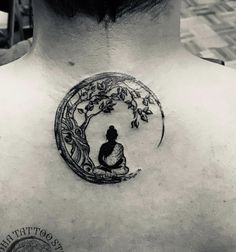 a man with a tattoo on his back that has a woman sitting under a tree