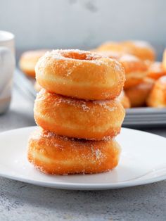 a stack of doughnuts sitting on top of a white plate