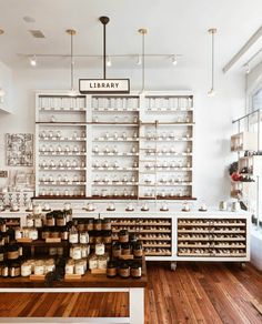 the inside of a library with shelves filled with jars