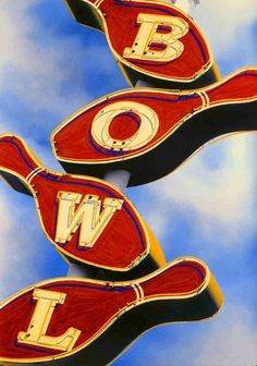 two red fish shaped signs with the letters bw and w on them in front of a cloudy blue sky