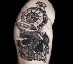 a man's arm with a clock and skull on it