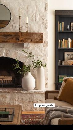 a living room filled with furniture and a fire place in front of a stone fireplace