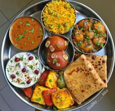 a metal plate topped with different types of food