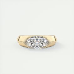 a yellow gold ring with an oval cut diamond in the center, on a white background