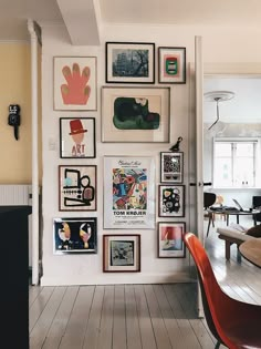 there are many framed pictures on the wall