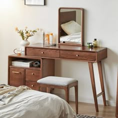 a bedroom scene with focus on the dressing table and stool, along with a bed