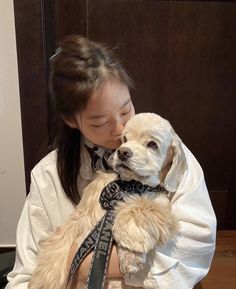 a woman holding a dog in her arms