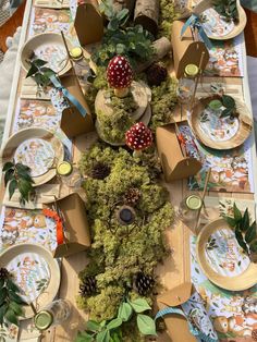 the table is decorated with moss and pine cones