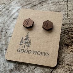 small wooden studs with the words good works on them sitting on top of a piece of wood