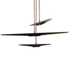 three black and gold objects hanging from the ceiling