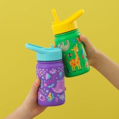 two children's sippy bottles in the shape of giraffes and elephants