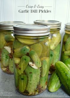 pickles in glass jars sitting on a counter