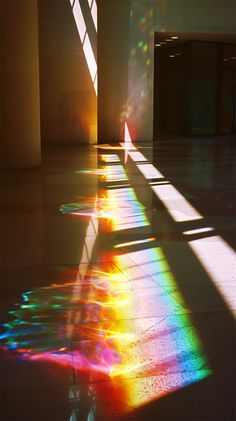 the sun is shining through some windows in an empty building with long shadows on the floor