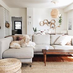 a dog is laying on the couch in this living room