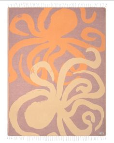 an orange and purple octopus rug on a white background with fringes in the foreground