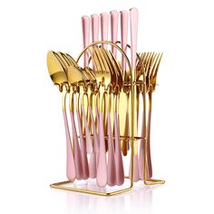 pink and gold utensils in a stand on a white background with reflection over the top