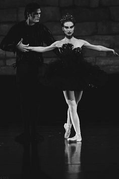 two ballerinas in black and white pose for the camera