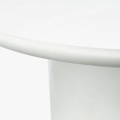 a close up of a white table with a curved design on the top and bottom