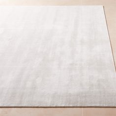 a large white rug on the floor with no one around it or in front of it