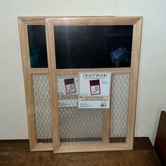 a wooden frame with chicken wire around it and a sign on the window that says gauffoo