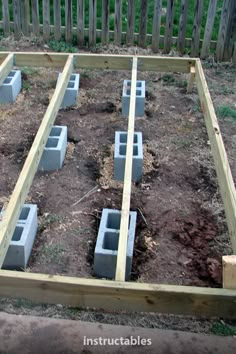 an outdoor garden with cinder blocks in the ground