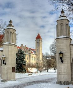 an old building with two towers in the middle of it and snow on the ground