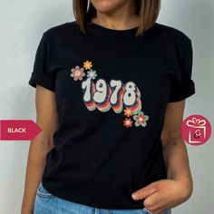 "Birthday Shirt 1978, Vintage T Shirt Vintage 1978 Tee 45th Birthday Gift for Women Christmas Custom Birthdate shirt Year of birth shirt Xmas ---------------------- 🛍️ How to Order Your Perfect T-Shirt 🌟 Welcome to our shop! We're thrilled you're here to customize your ideal T-shirt. To make your shopping experience seamless, follow these simple steps: 1️⃣ Explore All the Details: Take a close look at all the photos to ensure you know exactly what you're getting. 2️⃣ Size Matters: Use the convenient size chart in the dropdown menu and add each shirt to your cart one at a time. This ensures you get the perfect fit. 3️⃣ Color Your World: Select your favorite shirt color from the dropdown menu labeled \"Shirt Color.\" We offer a spectrum of choices to match your style. 4️⃣ Combine and Save: Vintage Crew Neck Top As Gift, Vintage Short Sleeve Tops For Gift, Retro Letter Print Tops For Gifts, Retro Letter Print Tops As Gift, Vintage Graphic Print Tops For Gifts, Vintage Graphic Print Tops As Gift, Vintage Screen Print Tops For Gift, Vintage Screen Print Tops As Gift, Retro Graphic Print Top For Gift