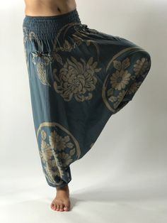 "These super soft rayon baggy unisex harem pants have the \"flow\", perfect of yoga or just a cool strolling. Comfort and character are what these pants are all about. They have the traditional sarong look & feel but a lot more practical when it comes to activity like yoga. As a bonus, they are convertible! Just pull them up and you get yourself a cute jumpsuit in a flash. Together with elastic cuff legs, you can wear them short or long. The pants have smock waist (wide bang elastic) with no Bohemian Stretch Harem Pants For Yoga, Relaxed Fit Harem Pants For Meditation, Meditation Harem Bottoms With Elastic Waistband, Relaxed Fit Harem Bottoms For Meditation, Comfortable Baggy Harem Pants For Yoga, Relaxed Fit Drop Crotch Harem Pants For Yoga, Baggy Wide Leg Harem Pants For Meditation, Stretch Drop Crotch Harem Pants For Yoga, Bohemian Relaxed Fit Yoga Pants