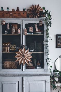 an old china cabinet decorated with paper stars