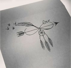 an arrow with the word love written on it and two birds flying around in the sky