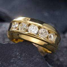 a yellow gold wedding band with five diamonds