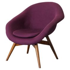 a purple chair with wooden legs on a white background