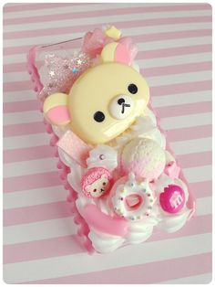 a pink and white phone case with a teddy bear on it's back cover