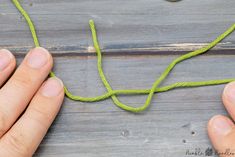 two hands are working on a piece of string