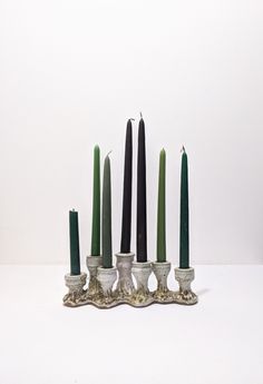 a group of candles sitting in front of each other on top of a white table