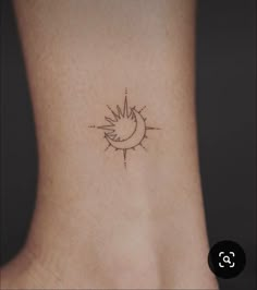 a small sun and moon tattoo on the back of a woman's neck,