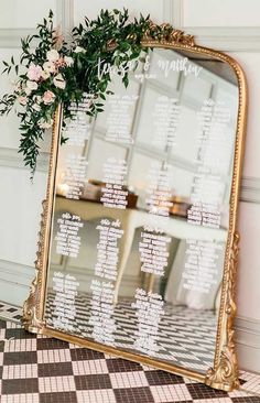 a large mirror sitting on top of a checkered floor