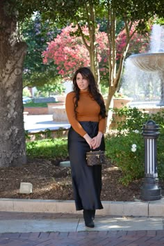 The quality is perfect! Thicker satin Elastic/drawstring waist, perfect to dress up or wear casual Maxi length Comfortable Perfect for all seasons Modeled in large 5'7", paired with our Rae mock-neck top 100% Polyester Small (waist 28-30”/hips 40"/length 38”) Medium (waist 30-32”/hips 42"/length 38”) Large (waist 32-34”/hips 44"/length 38”) *To measure yourself: Bust - measure the widest part of your bust with your bra on. Waist - measure the most narrow part (usually bellybutton) Hips - measure most widest part around thighs (usually 10 inches from waist) Chic Satin Skirt For Fall, Chic Fall Skirt With Tie Waist, Long Black Skirt Fall Outfit, Long Black Skirt Outfit Fall, Black Satin Maxi Skirt Outfit, Black Women Business Casual, Silk Maxi Skirt Outfit, Black Skirt Outfit Fall, Black Satin Skirt Outfit