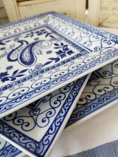 three blue and white plates stacked on top of each other