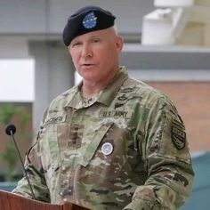 a man in uniform giving a speech at a podium